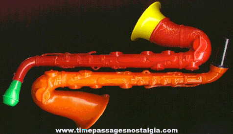 (2) Different Old Colored Hard Plastic Toy Saxophone Horns