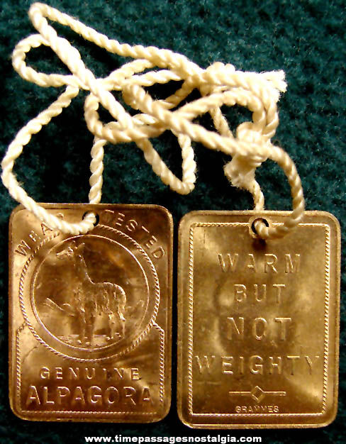 (2) Old Alpagora Clothing Advertising Brass Medallion Tags with Strings
