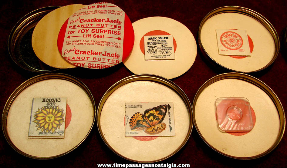 (5) Early 1970s Cracker Jack Peanut Butter Jar Advertising Lids with Different Unopened Toy Prizes