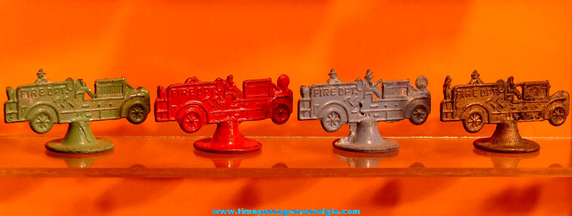 (4) Colorful Old Cracker Jack Pop Corn Confection Pot Metal or Lead Toy Prize Fire Engine Trucks